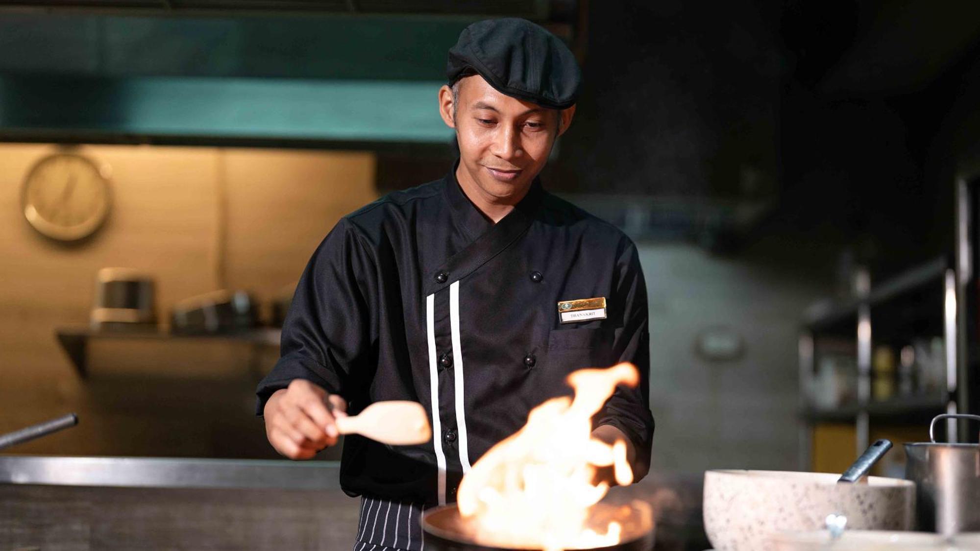 Phuket Graceland Resort And Spa Patong Exterior photo A chef cooking with a wok