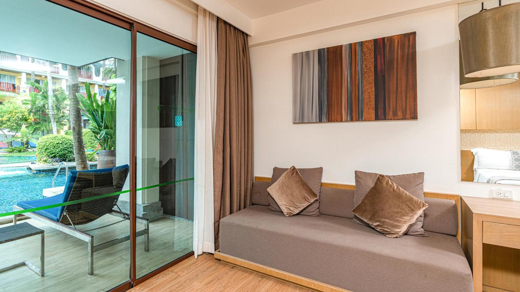 Phuket Graceland Resort And Spa Patong Exterior photo A living room with a sofa